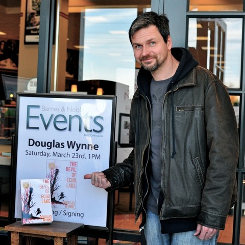Douglas Wynne beside a Barnes & Noble event sign.